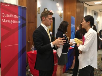 Master's student, Yumeng Ma, talks with a Bank of America representative at the 2017 Career Fair 